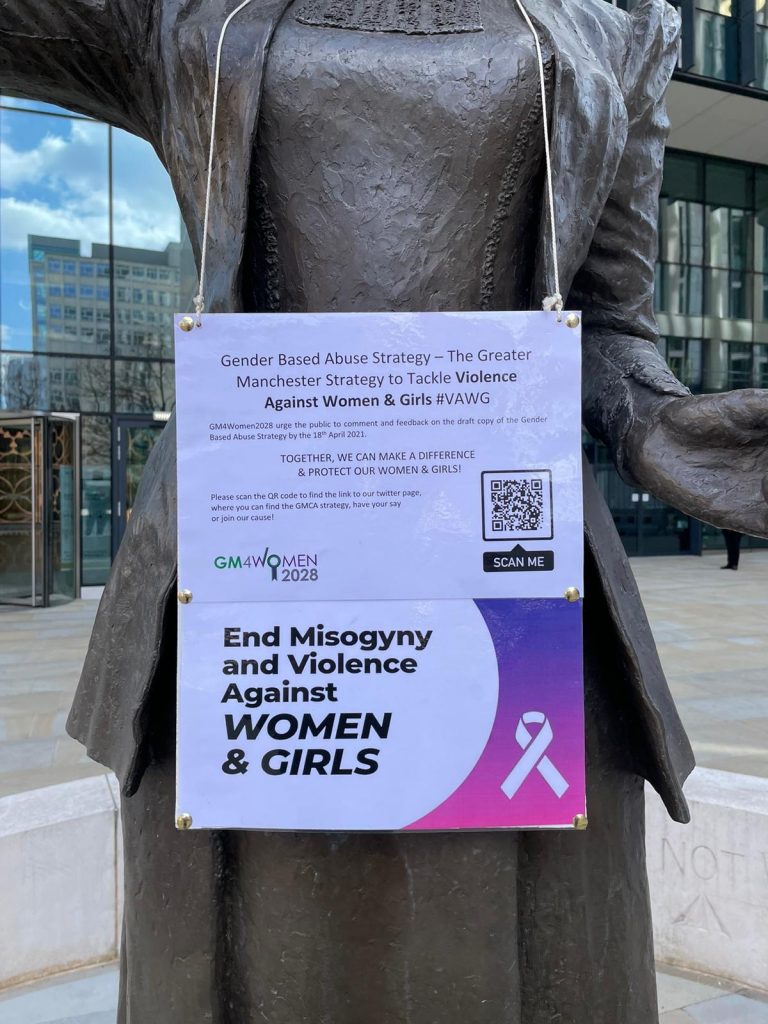 Statue with Sign saying end misogyny and violence against women and girls